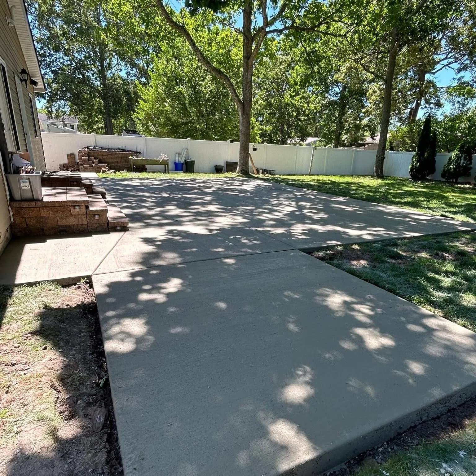 Finished concrete patio in a fenced South Jersey backyard